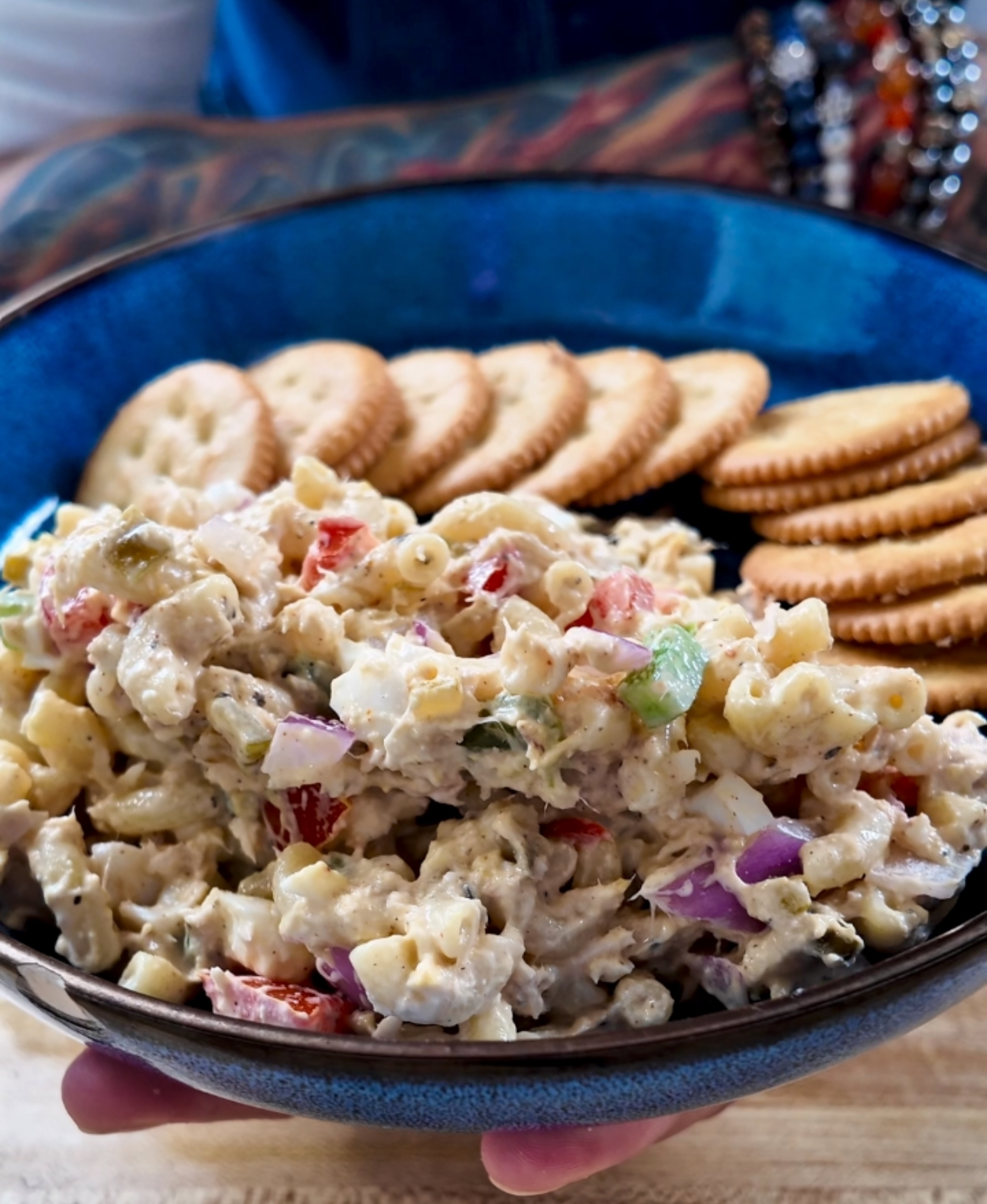 tuna macaroni salad in a blue bowl with buttery Ritz crackers