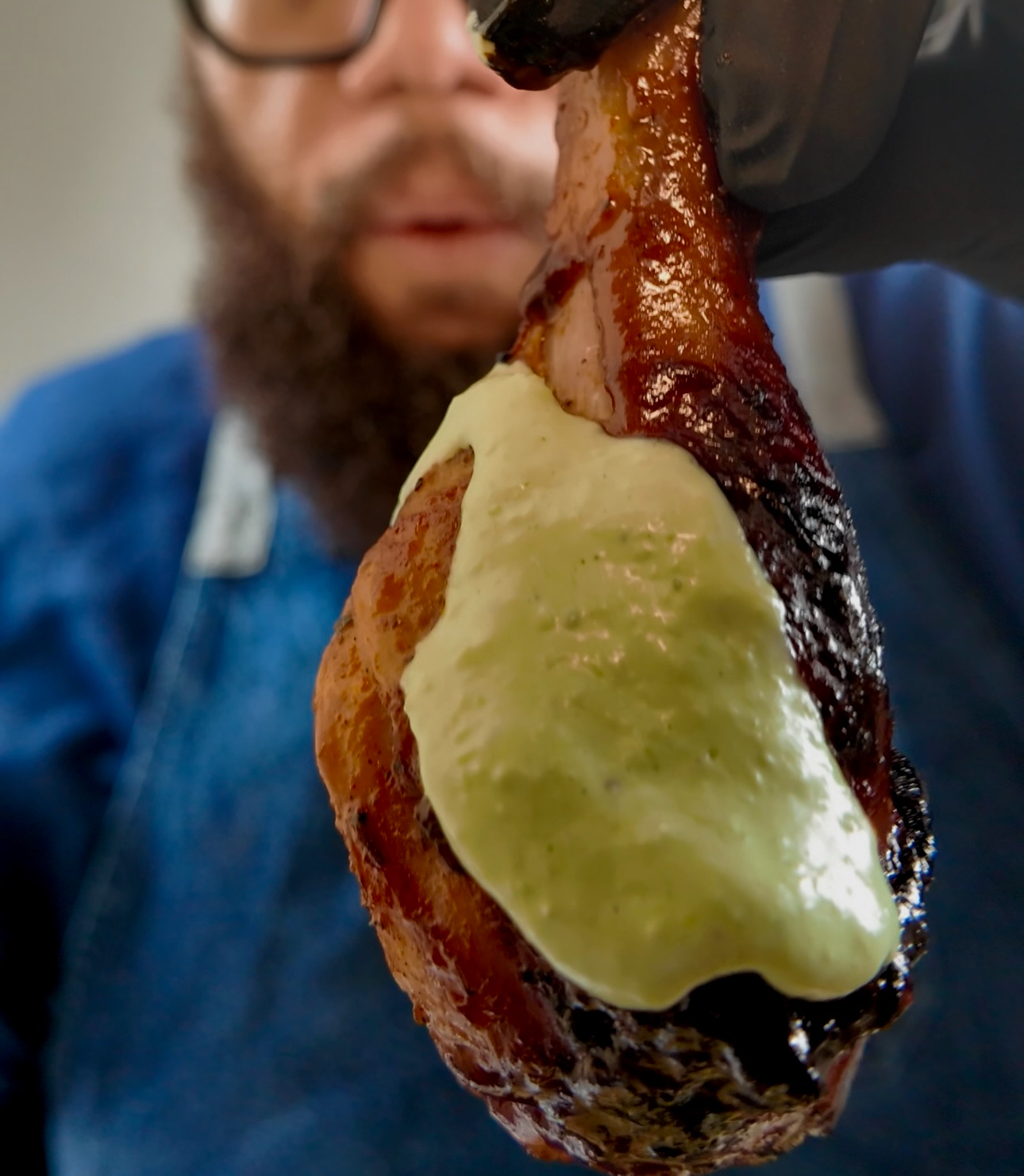 Air fryer Peruvian BBQ chicken coated with Peruvian Green Sauce, also known as Aji Verde.